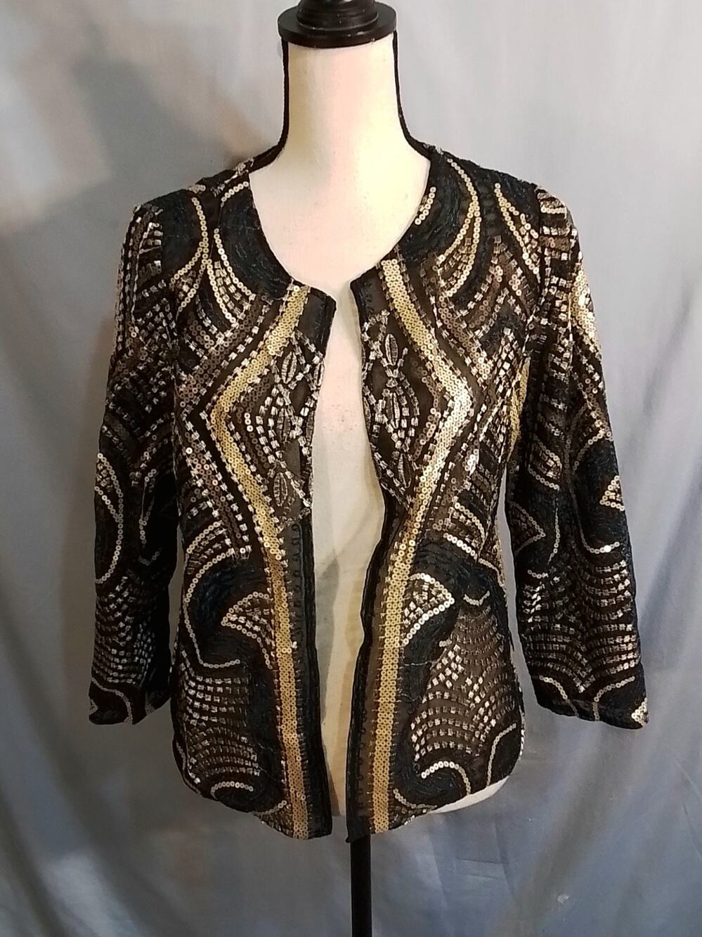 Chico's black dress jacket with gold and blue stitching.